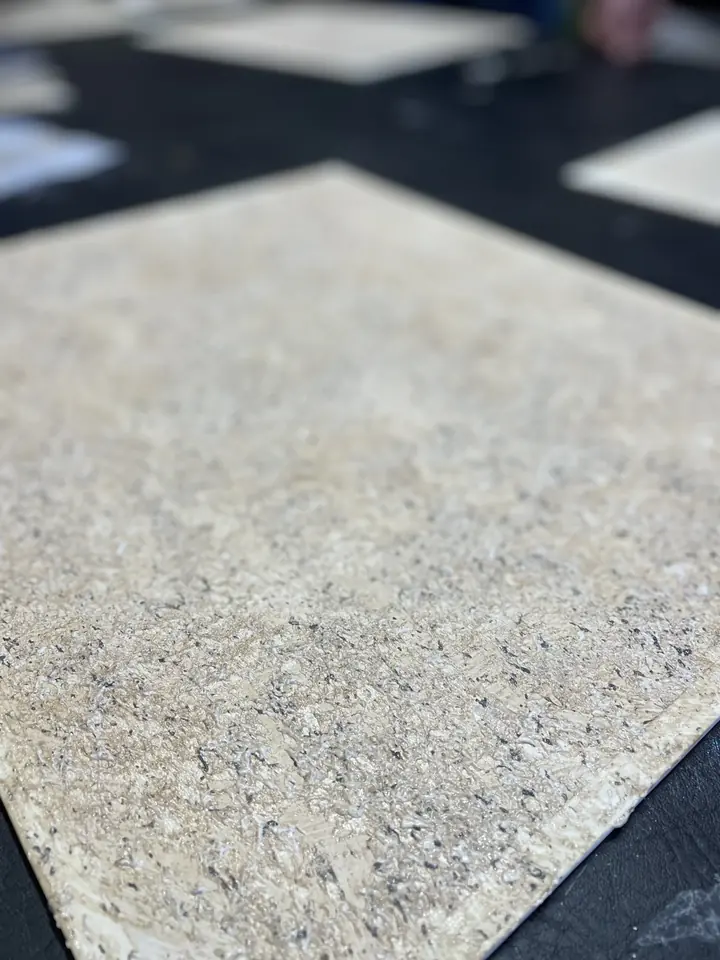 Close-up of a textured finish sample with a fine speckled surface