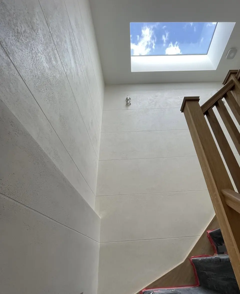 Islington entrance hall with warm polished plaster walls and a softly reflective mineral finish detail view