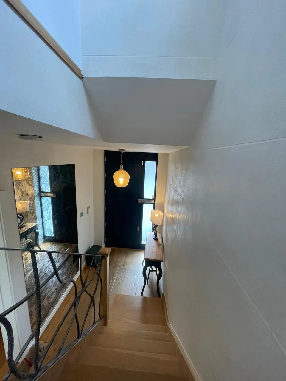 Islington entrance hall with warm polished plaster walls and a softly reflective mineral finish work detail
