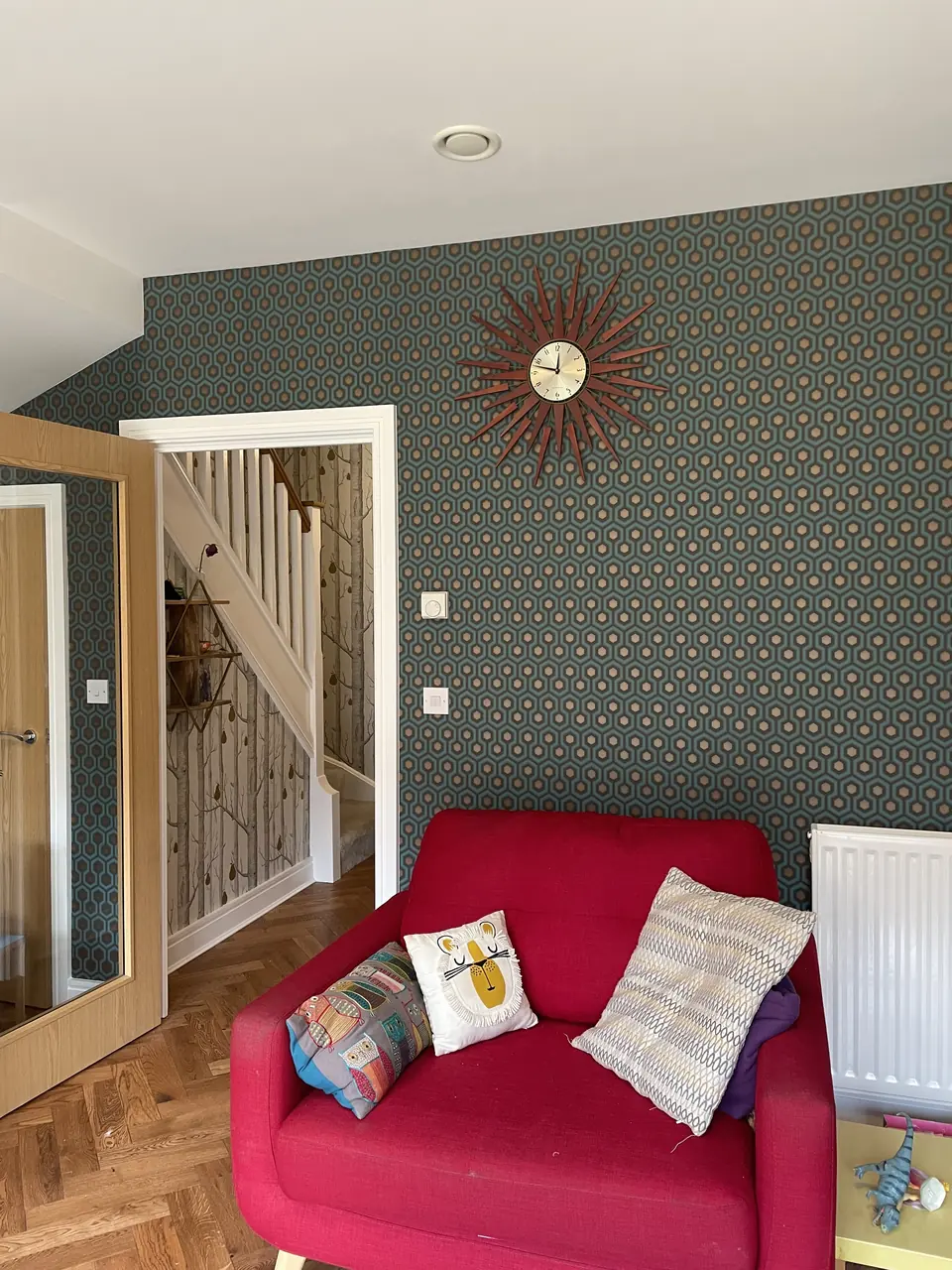 Bold geometric wallpaper hung through an entrance hall