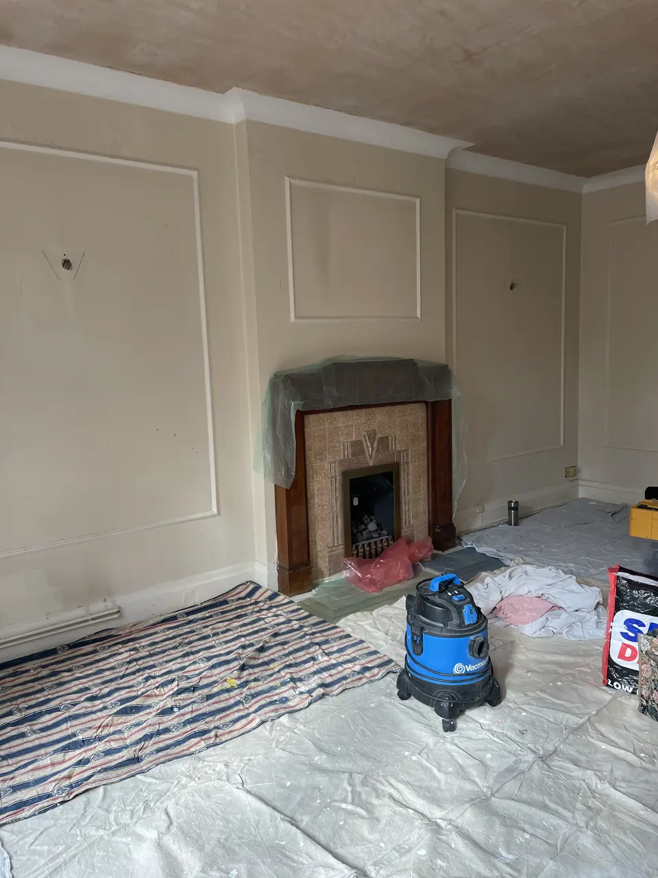 Highgate reception room with sage-painted walls, botanical wallpaper and original period detailing detail view