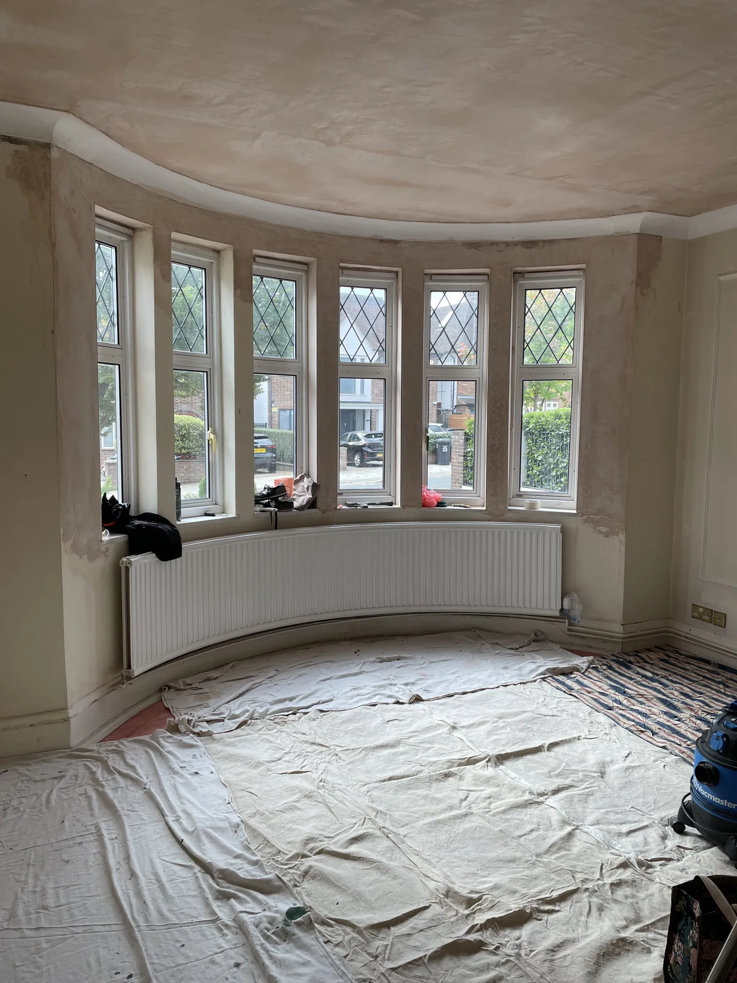 Highgate reception room with sage-painted walls, botanical wallpaper and original period detailing finished room view