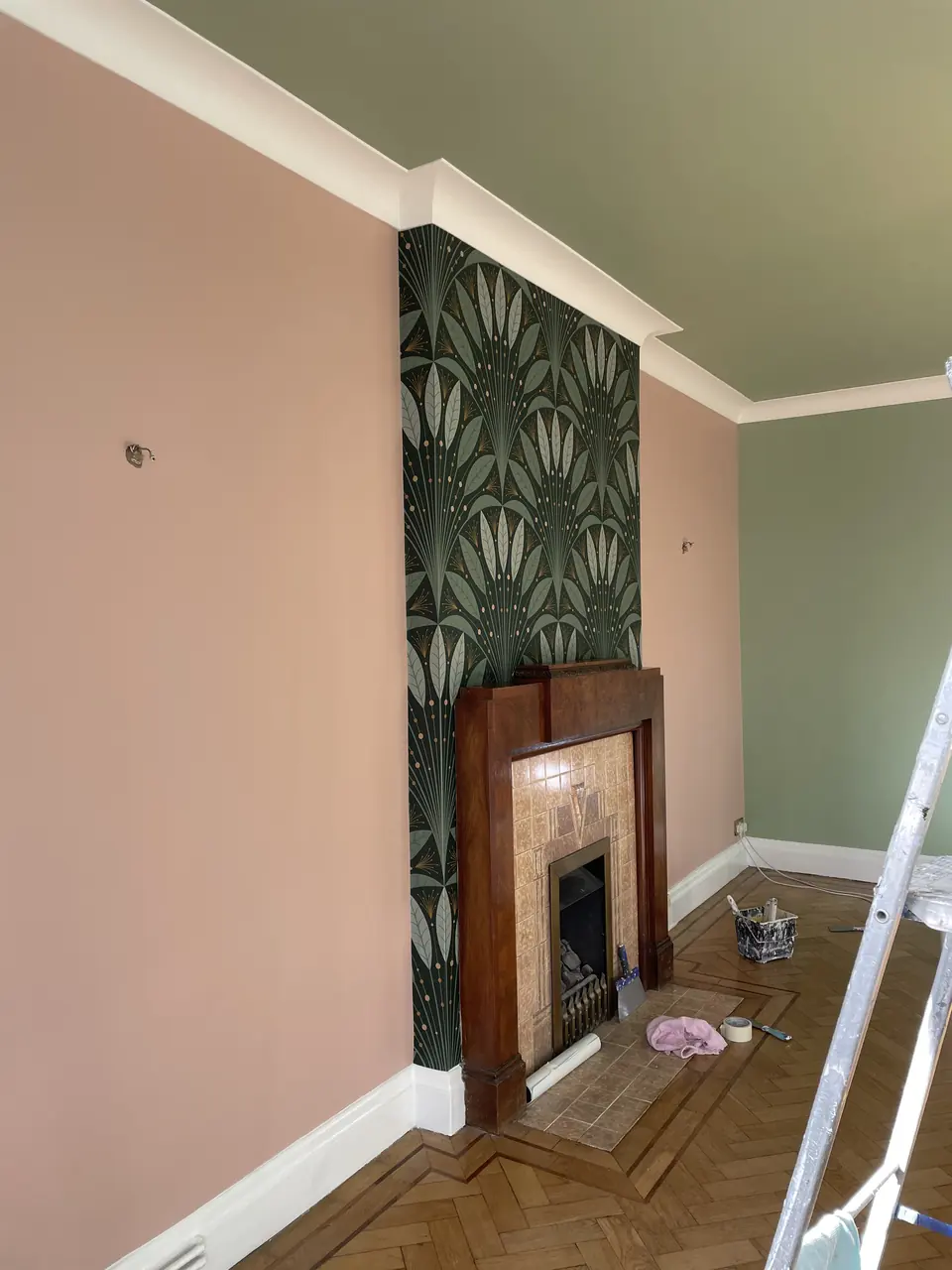 Highgate reception room with sage-painted walls, botanical wallpaper and original period detailing close detail