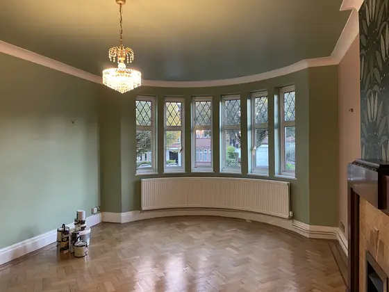 Highgate reception room with sage-painted walls, botanical wallpaper and original period detailing additional project view 1