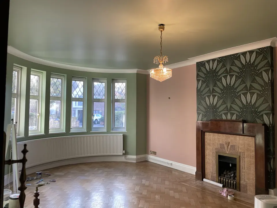 Highgate reception room with sage-painted walls, botanical wallpaper and original period detailing