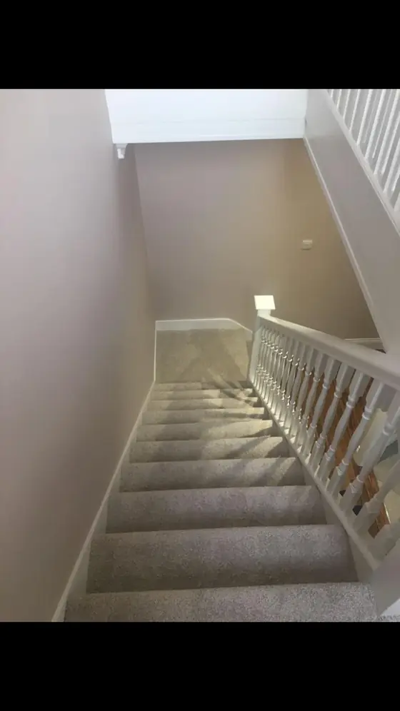 Close view of hand-painted white stair spindles and banister