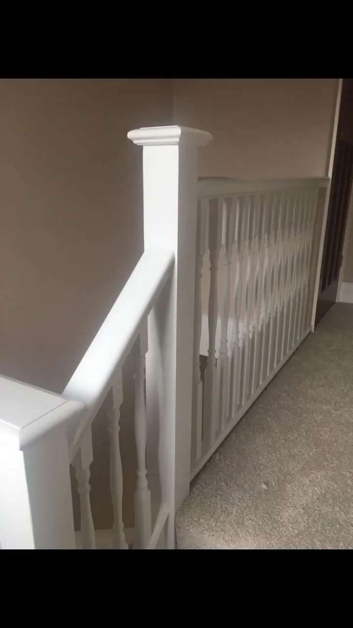 Crouch End period stairwell with restored white balusters, stained wooden treads and warm white walls finished room view