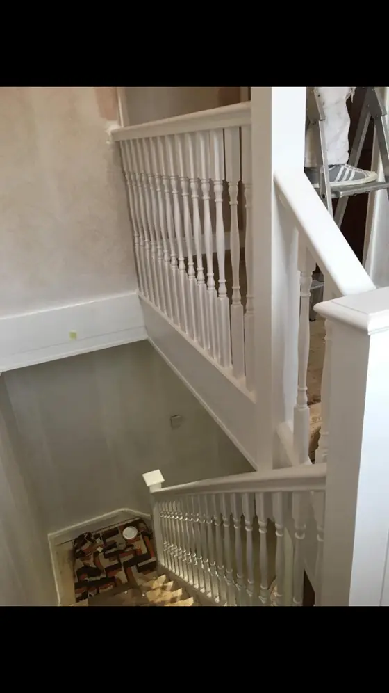 Crouch End period stairwell with restored white balusters, stained wooden treads and warm white walls additional project view 2