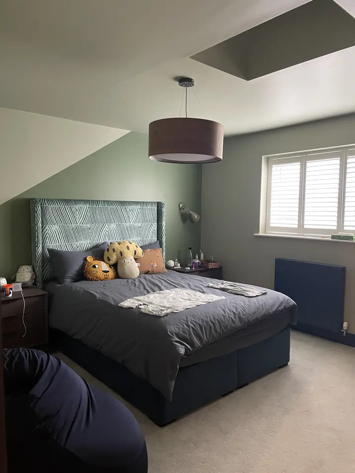 Painted bedroom feature wall with deep colour and sharp geometric edge