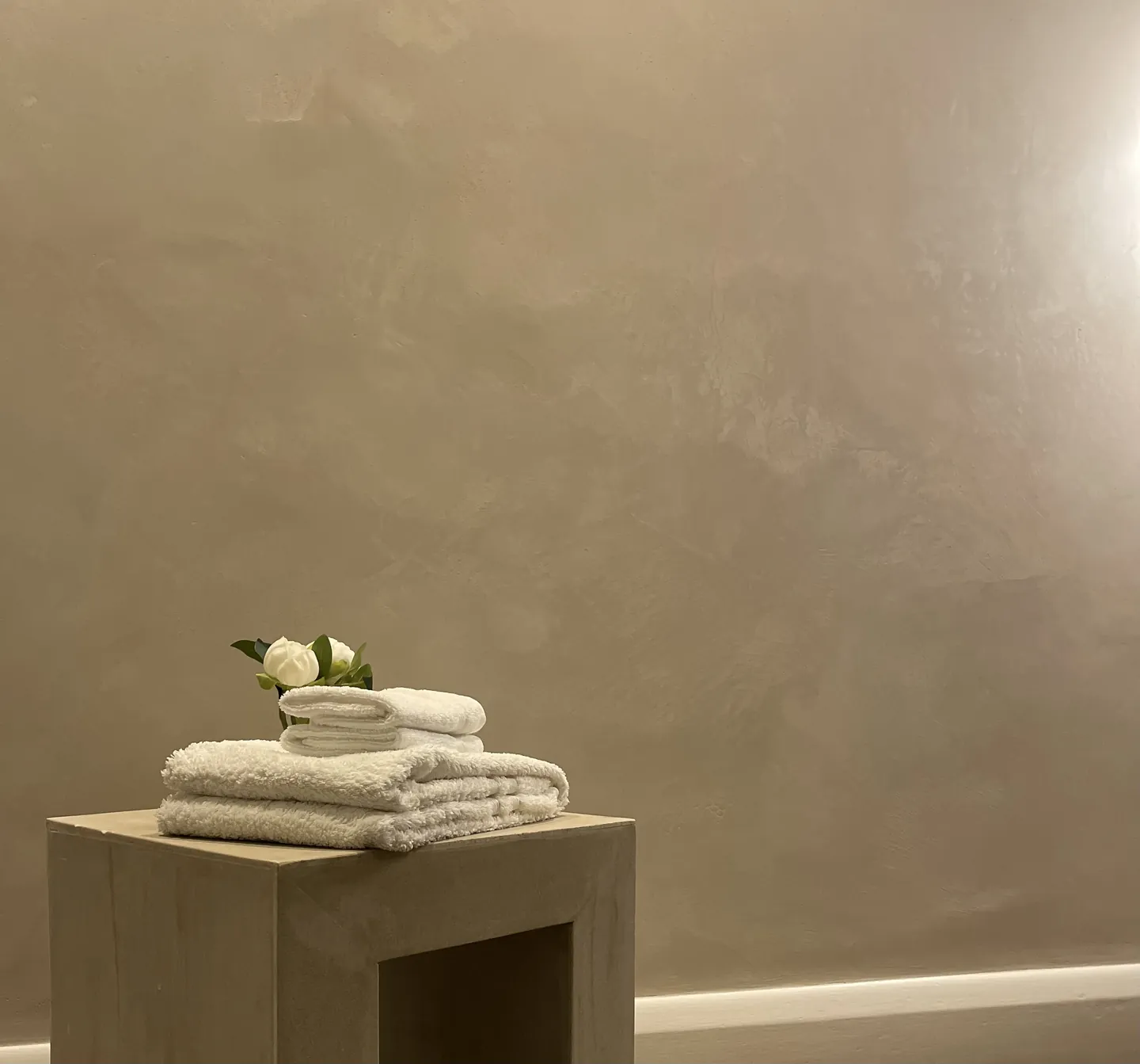 Hampstead interior with warm Venetian plaster carried through connected living spaces opening view